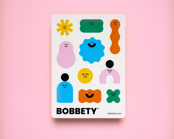 Sticker sheet with colorful character stickers on a pink background, featuring the brand 'Bobbety'.