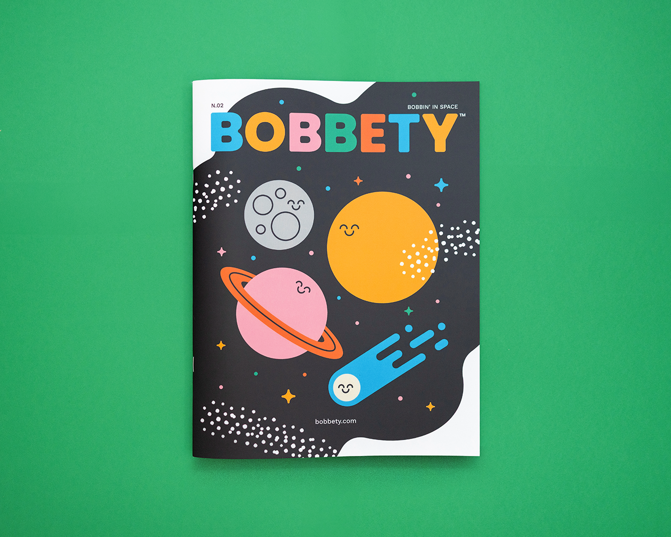 Bobbety Magazine cover with space objects on a green background