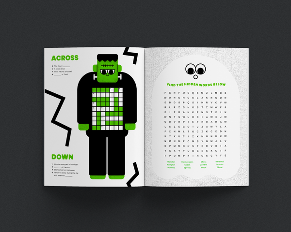 Open magazine with a halloween-themed crossword puzzle and word search.