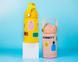 Two colorful water bottles with Bobbety stickers on a blue background