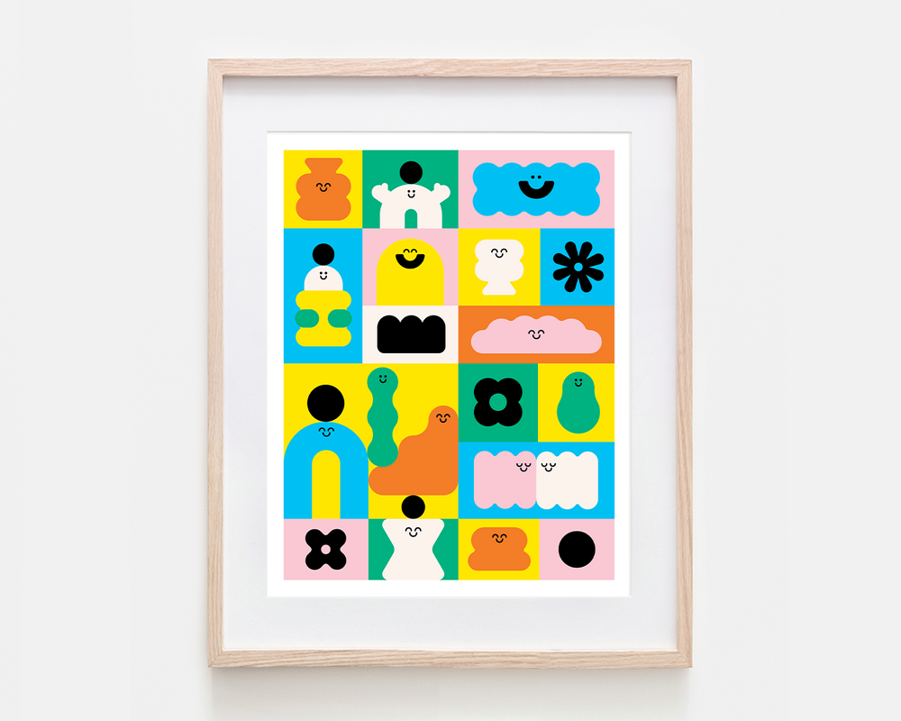 A framed art print featuring colorful cute, abstract cartoon characters and shapes in bright pastel and primary colors, set in a light natural wood frame against a clean white background.