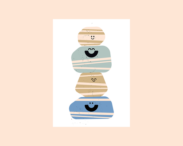 A minimalist art print featuring a stack of four stylized, smiling stones in beige, light blue, tan, and medium blue, set against a white square card on a soft peach background.