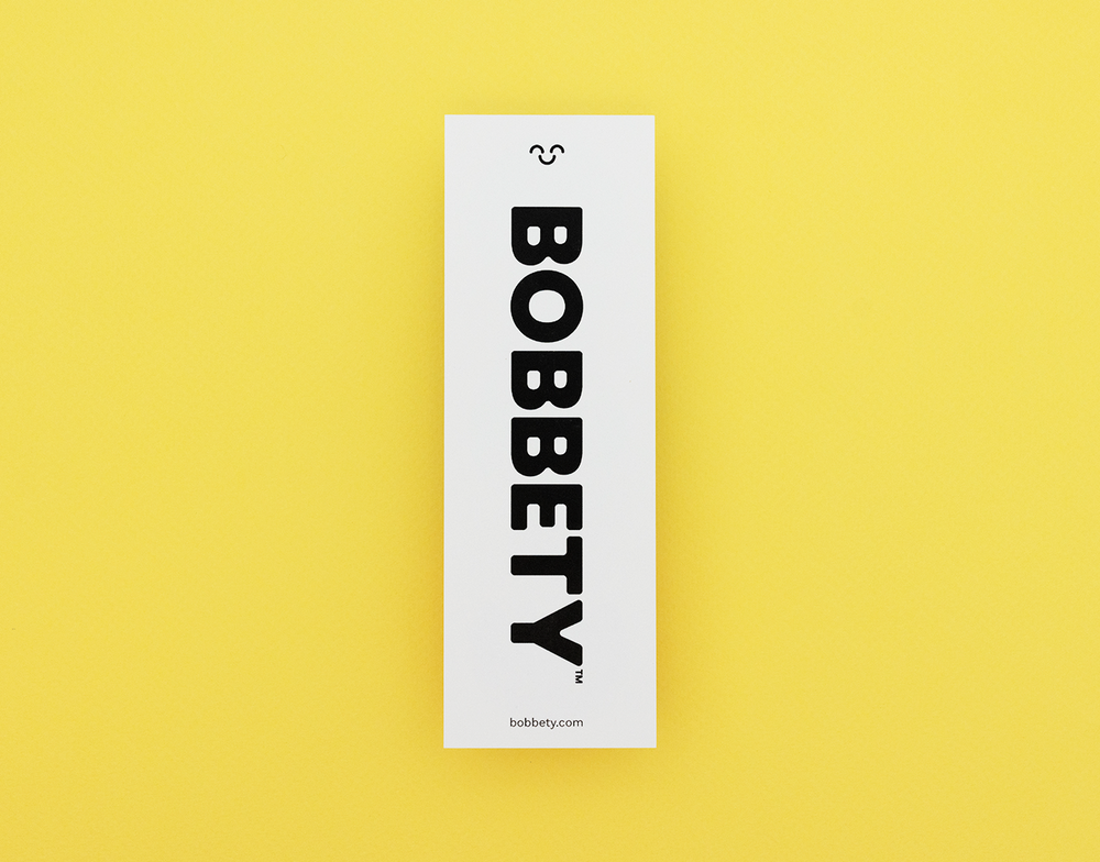 Three colorful monster bookmark on a white card against a yellow background
