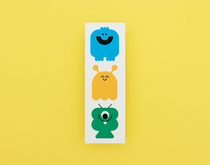 Three colorful monster bookmark on a white card against a yellow background