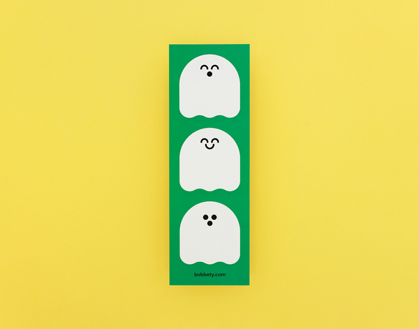 Three cartoon ghosts on a green bookmark with a yellow background