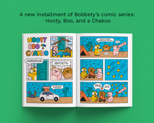 An open comic book spread titled 'Hooty Boo and Chakko' shown on a bright green background with text above reading 'A new installment of Bobbety's comic series: Hooty, Boo, and a Chakoo.' The comic features cartoon animals in a campsite scene with stars, a tent, a car, and speech bubbles.