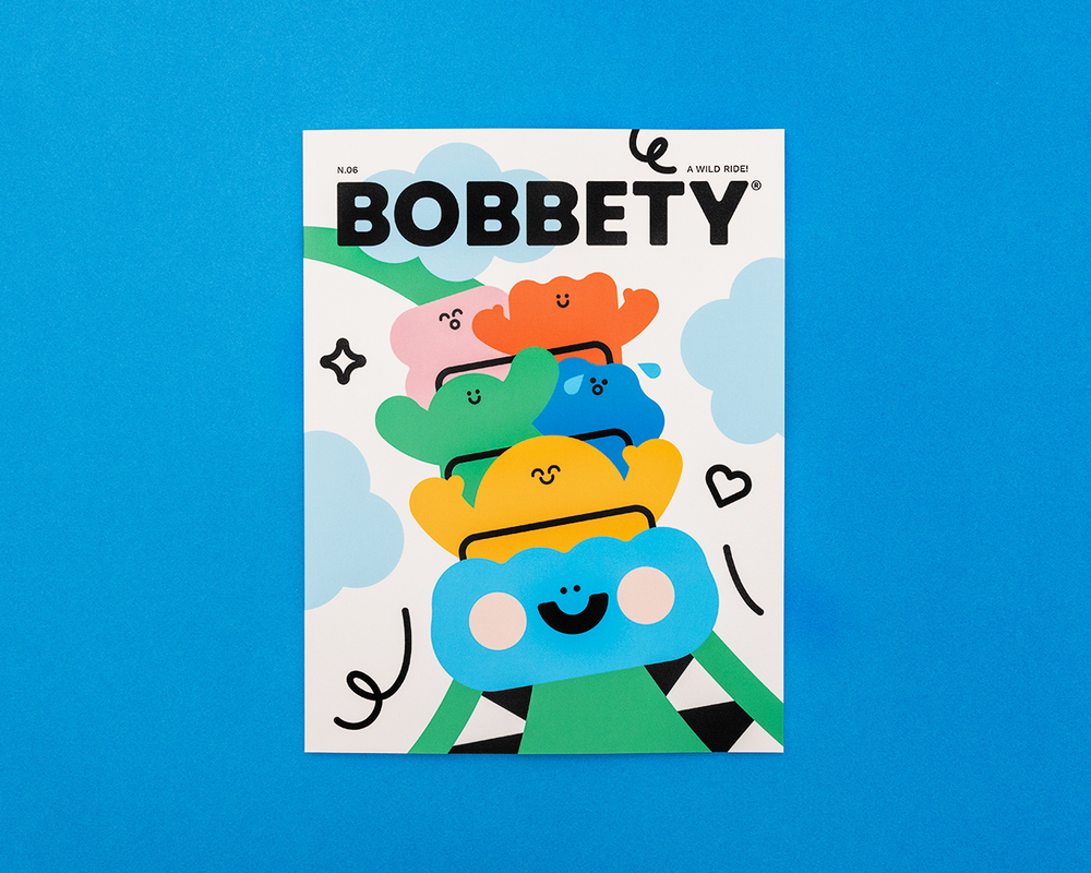 Magazine cover titled 'Bobbety' with colorful character illustration on a blue background
