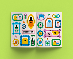 Open magazine with colorful characters on a green background