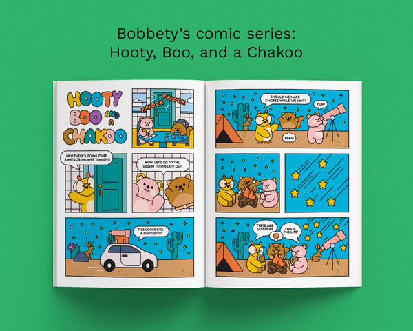 Comic book open to a page with cartoon characters on a green background